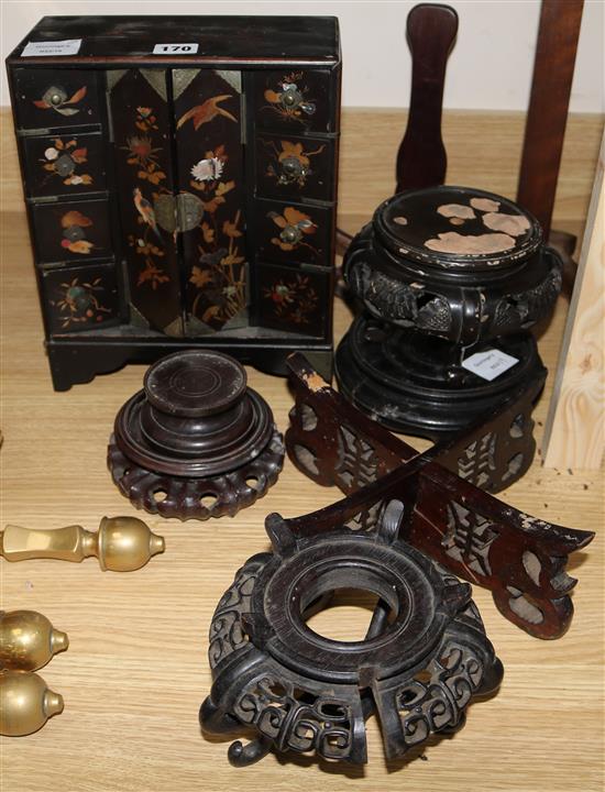 A Japanese lacquer cabinet and various Oriental wood stands